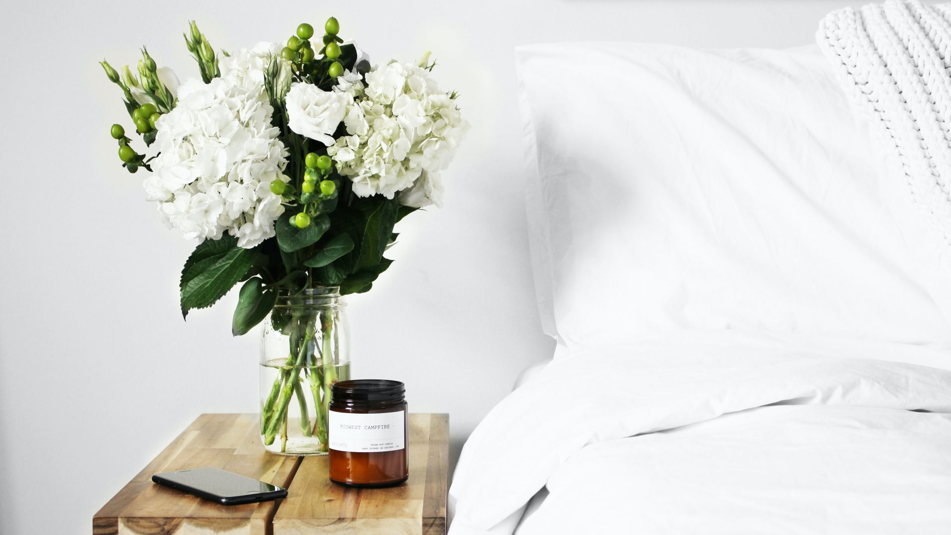 flowers in clear glass vase on table